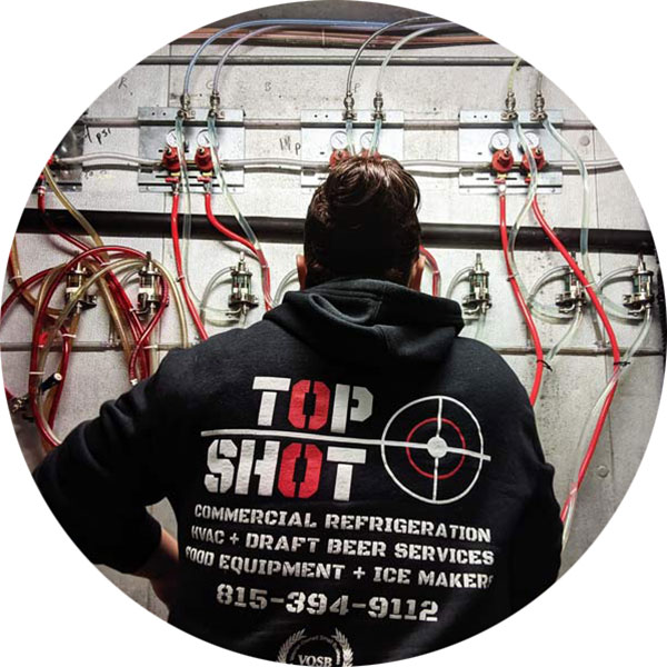 Catie Seivert performing beer line maintenance for TopShot
